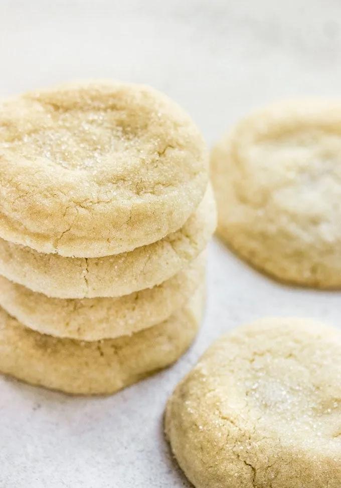 Stack of golden soft sugar cookies with sparkly sugar coating, showing tender crumb texture
