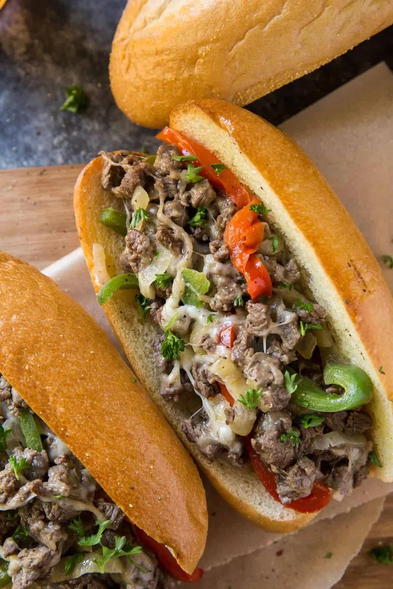 Authentic Philly cheesesteak sandwich with melted provolone cheese, tender sirloin beef, sautéed peppers and onions on toasted hoagie roll