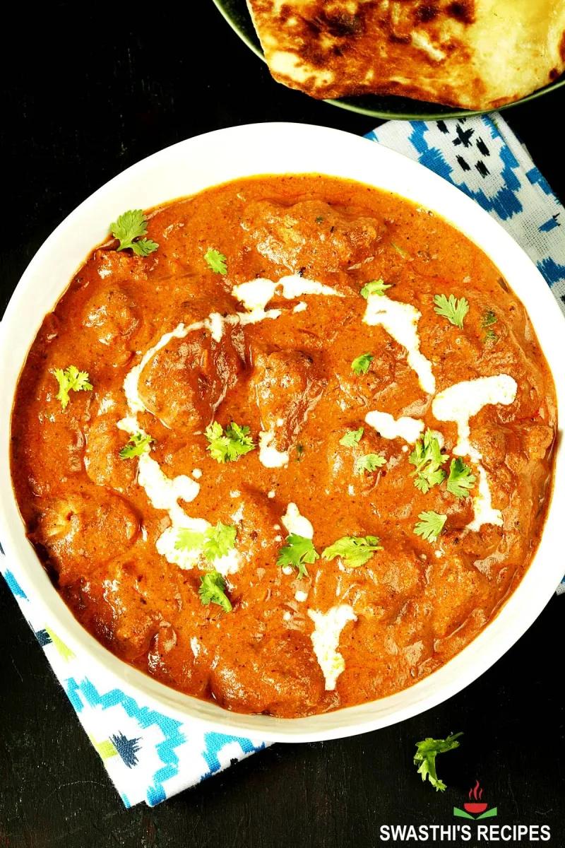 Creamy chicken tikka masala with tender grilled chicken pieces in rich tomato sauce, garnished with fresh cilantro